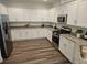 Modern kitchen featuring white cabinets, stainless steel appliances, and granite countertops at 2026 Sidney St, Clearwater, FL 33763