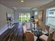 Open-concept living room with wood floors, ample natural light, and stylish furnishings at 2026 Sidney St, Clearwater, FL 33763