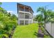 Beautiful backyard with lush green lawn and tropical plants at 2200 N Glenwood Dr, Tampa, FL 33602