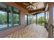 Wide balcony shows wood tile flooring, wood ceiling, and railing with a view of trees at 2200 N Glenwood Dr, Tampa, FL 33602