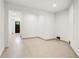 Bright, painted basement room with sleek and smooth terrazzo flooring, and a view of the front door at 2200 N Glenwood Dr, Tampa, FL 33602