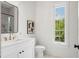 Bright bathroom features a modern vanity, sleek mirror, and an expansive window providing natural light at 2200 N Glenwood Dr, Tampa, FL 33602