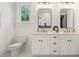 Bathroom with a double sink vanity, framed mirrors, and decorative light fixtures at 2200 N Glenwood Dr, Tampa, FL 33602