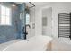 Bright bathroom featuring a soaking tub, blue tiled shower, and modern fixtures at 2200 N Glenwood Dr, Tampa, FL 33602