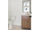 Bathroom features a toilet, sink, modern vanity and mirror at 2200 N Glenwood Dr, Tampa, FL 33602
