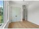 Light-filled bedroom featuring hardwood floors and closet at 2200 N Glenwood Dr, Tampa, FL 33602