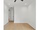 Bright, empty bedroom features hardwood floors, a ceiling fan, recessed lights and access to hallway through a white door at 2200 N Glenwood Dr, Tampa, FL 33602
