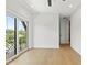 Spacious bedroom with modern fan, light floors, and balcony overlooking city at 2200 N Glenwood Dr, Tampa, FL 33602