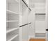 Bright walk-in closet featuring custom white shelving and dark hardware for a clean, organized space at 2200 N Glenwood Dr, Tampa, FL 33602