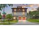 Stunning two-story home with balconies and a two-car garage under a sunset sky at 2200 N Glenwood Dr, Tampa, FL 33602