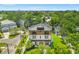 Aerial view of a modern home with a black roof, beautiful landscaping, and a well-manicured lawn at 2200 N Glenwood Dr, Tampa, FL 33602