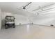 Spacious garage with epoxy floors, a golf cart, and ample room for parking and storage at 2200 N Glenwood Dr, Tampa, FL 33602
