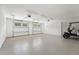 Large, well-lit garage featuring epoxy flooring and two white garage doors for easy vehicle access at 2200 N Glenwood Dr, Tampa, FL 33602