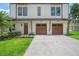 Close up of the two car garage with matching front door, well-maintained landscaping, and a modern design at 2200 N Glenwood Dr, Tampa, FL 33602