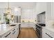 Modern white kitchen with stainless steel refrigerator, island, and stainless steel oven and range at 2200 N Glenwood Dr, Tampa, FL 33602