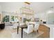 Open-concept living space featuring a modern chandelier, a full kitchen, and dining table at 2200 N Glenwood Dr, Tampa, FL 33602