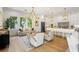 Bright open-concept living room featuring a modern chandelier, neutral furniture, and lots of natural light at 2200 N Glenwood Dr, Tampa, FL 33602