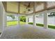 Large covered patio with fan, wood ceiling, stone floors and view of the green backyard at 2200 N Glenwood Dr, Tampa, FL 33602