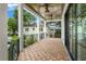 Inviting porch features wood-look tile flooring, ceiling fans, and views of lush greenery and neighborhood homes at 2200 N Glenwood Dr, Tampa, FL 33602
