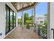 Relaxing covered porch with wood-look flooring, black metal railings, and neighborhood views at 2200 N Glenwood Dr, Tampa, FL 33602