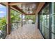Cozy covered porch featuring attractive flooring, ceiling fans, and neighborhood views with black metal railings at 2200 N Glenwood Dr, Tampa, FL 33602