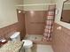 Bathroom features tiled walls, tiled shower stall, a white toilet, and a granite vanity at 2263 Americus E Blvd # 25, Clearwater, FL 33763