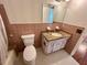 Retro bathroom with pink tile, granite vanity, and white fixtures at 2263 Americus E Blvd # 25, Clearwater, FL 33763