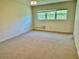 Carpeted bedroom featuring a window and overhead lighting at 2263 Americus E Blvd # 25, Clearwater, FL 33763
