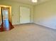 Carpeted bedroom featuring a closet and a wood hallway at 2263 Americus E Blvd # 25, Clearwater, FL 33763