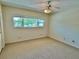 This spacious bedroom features a ceiling fan and a large window at 2263 Americus E Blvd # 25, Clearwater, FL 33763