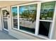 Unit 25 with large windows and balcony view of parking and trees at 2263 Americus E Blvd # 25, Clearwater, FL 33763