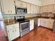 Updated kitchen featuring stainless steel appliances and beautiful granite countertops at 2263 Americus E Blvd # 25, Clearwater, FL 33763