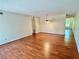 Open-concept living room with wood floors and a hallway leading to another room at 2263 Americus E Blvd # 25, Clearwater, FL 33763