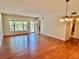 Bright living room with wood floors, open door, and natural light from the windows at 2263 Americus E Blvd # 25, Clearwater, FL 33763