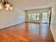 Sunlit living room features wood floors, an open door, and scenic window views at 2263 Americus E Blvd # 25, Clearwater, FL 33763
