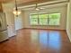 Bright living room featuring wood floors, ceiling fan and a large window view at 2263 Americus E Blvd # 25, Clearwater, FL 33763