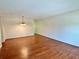 Spacious living room featuring wood floors and a decorative light fixture at 2263 Americus E Blvd # 25, Clearwater, FL 33763
