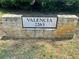 Stone sign indicating address for Valencia with greenery visible behind it at 2263 Americus E Blvd # 25, Clearwater, FL 33763