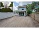 New construction home featuring large backyard with unfinished landscaping, and a rendering of the finished product at 2301 N Ridgewood Ave, Tampa, FL 33602