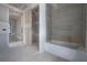 Spacious bathroom under construction showcasing the tiled shower and bath at 2301 N Ridgewood Ave, Tampa, FL 33602