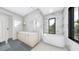 Modern bathroom with dual vanity, soaking tub, stylish tile, and a bright window view at 2301 N Ridgewood Ave, Tampa, FL 33602