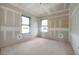 Spacious bedroom under construction with two windows and ready for finishing touches at 2301 N Ridgewood Ave, Tampa, FL 33602