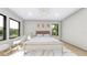 Bright main bedroom featuring modern art, a ceiling fan, and two bright windows at 2301 N Ridgewood Ave, Tampa, FL 33602