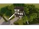 Striking three-story home with a balcony, garage, and beautifully landscaped yard at 2301 N Ridgewood Ave, Tampa, FL 33602