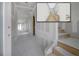 Spacious hallway with unpainted drywall, unfinished wooden stairs, and a rendering in the upper right corner at 2301 N Ridgewood Ave, Tampa, FL 33602