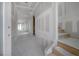 Spacious hallway with unpainted drywall, unfinished wooden stairs, and an open door at the end of the hall at 2301 N Ridgewood Ave, Tampa, FL 33602