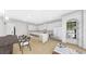 Modern kitchen with white cabinets, a marble island with bar stools, and a dining area with a wooden table at 2301 N Ridgewood Ave, Tampa, FL 33602
