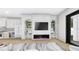 Modern living room featuring electric fireplace, built-in shelving, and light hardwood floors at 2301 N Ridgewood Ave, Tampa, FL 33602