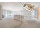 Large room with unfinished walls, and a rendering showing the spacious living and kitchen layout at 2301 N Ridgewood Ave, Tampa, FL 33602