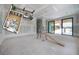 Large living room featuring a floorplan view, walls ready for finishing, and access to covered patio at 2301 N Ridgewood Ave, Tampa, FL 33602